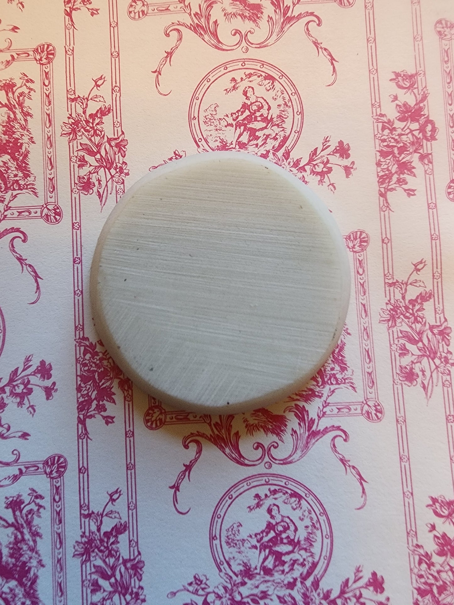 This is a plate or wall decor. It could even be a window for a haunted house or castle.