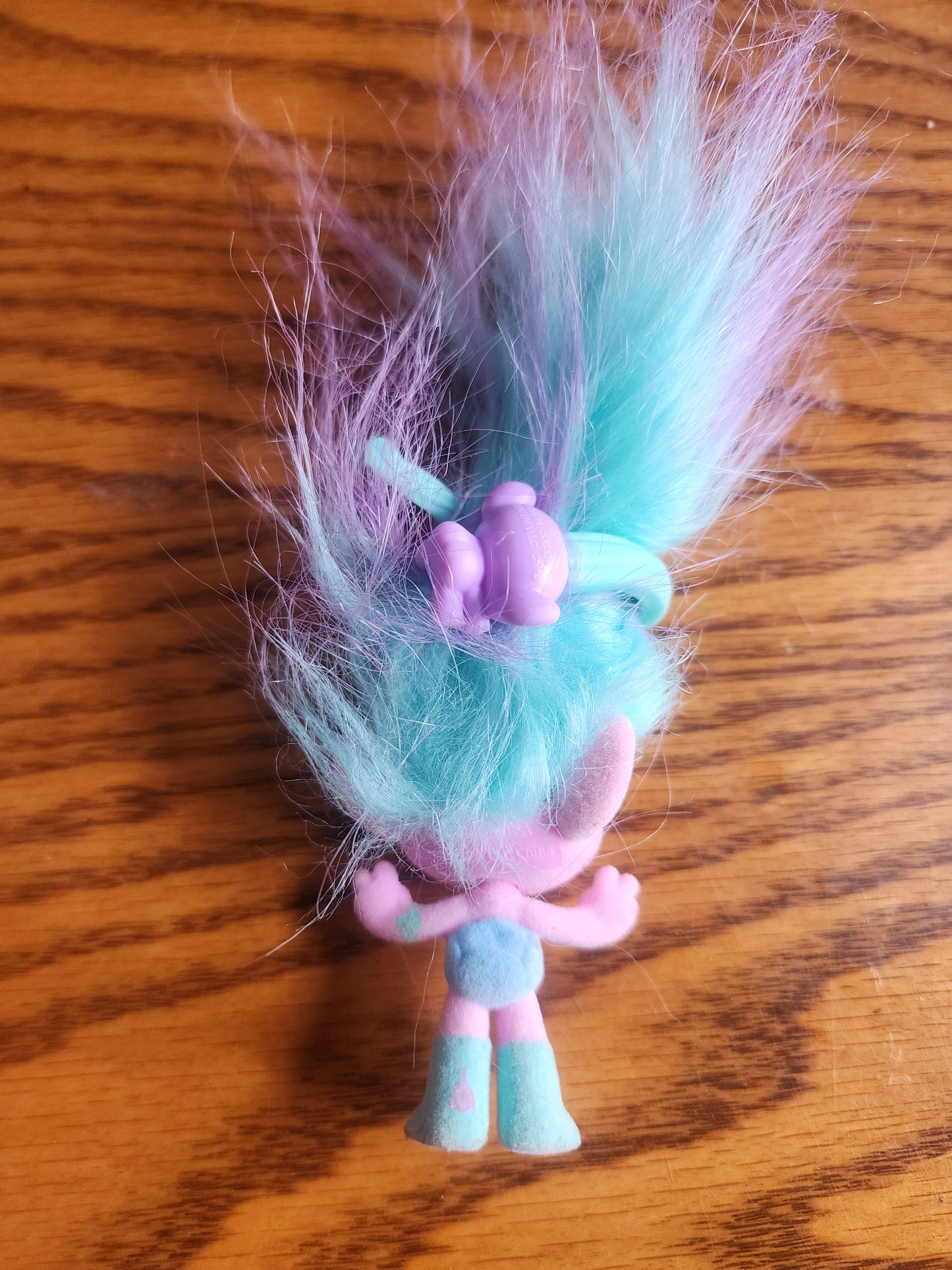 DreamWorks Trolls Chenille mini toy figurine.
The figure has a flocked (fuzzy) pink body and face.