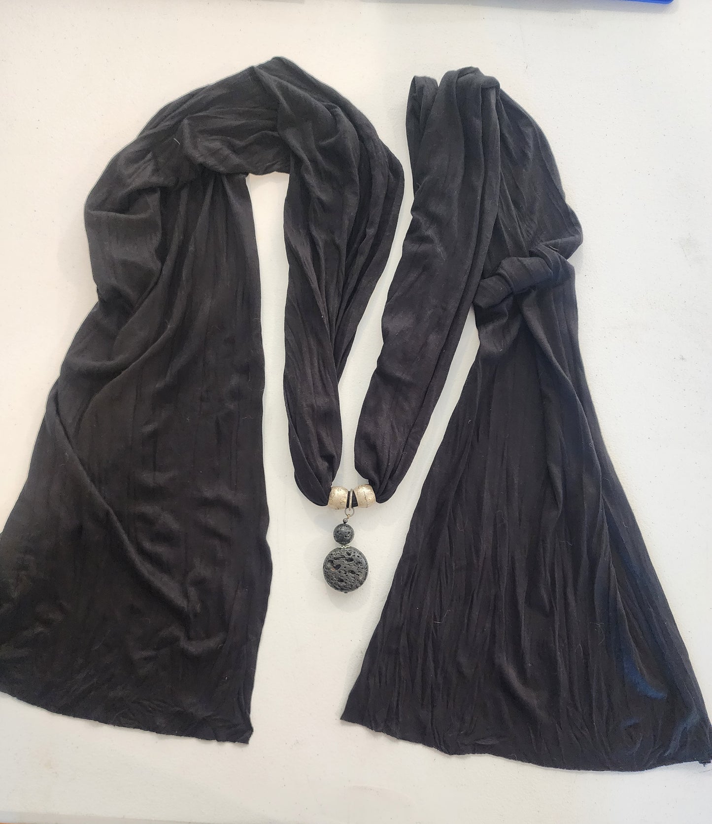 <span;>Black scarf with silver tone beads and black lava bead in middle of scarf.