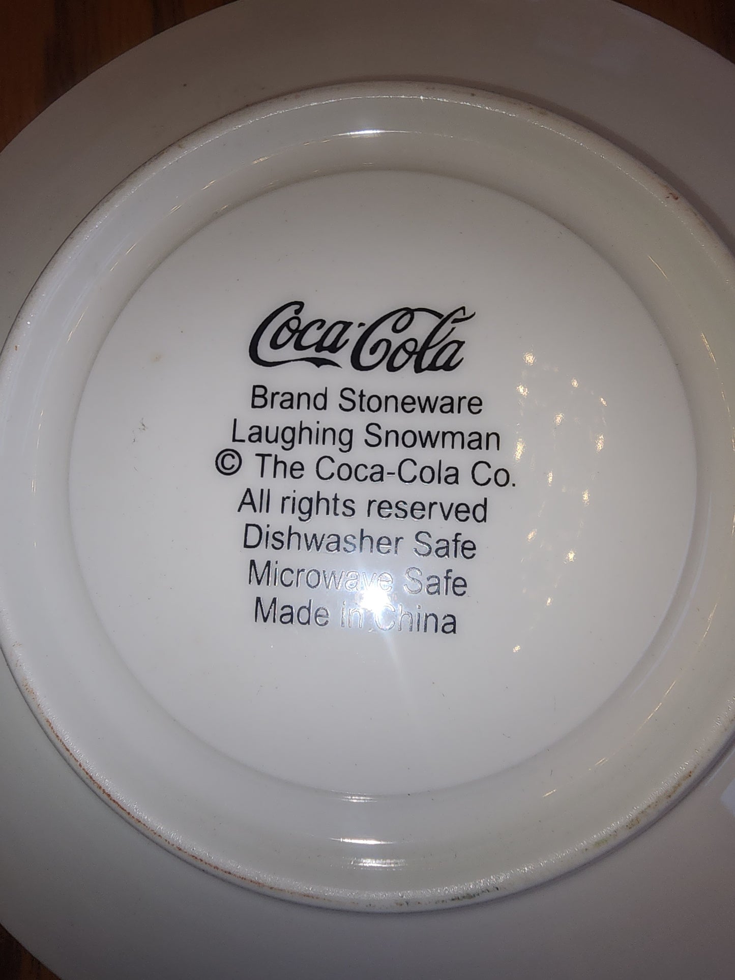 The Coca Cola Company Laughing Snowman. 2 Saucers. Blue, red, white.