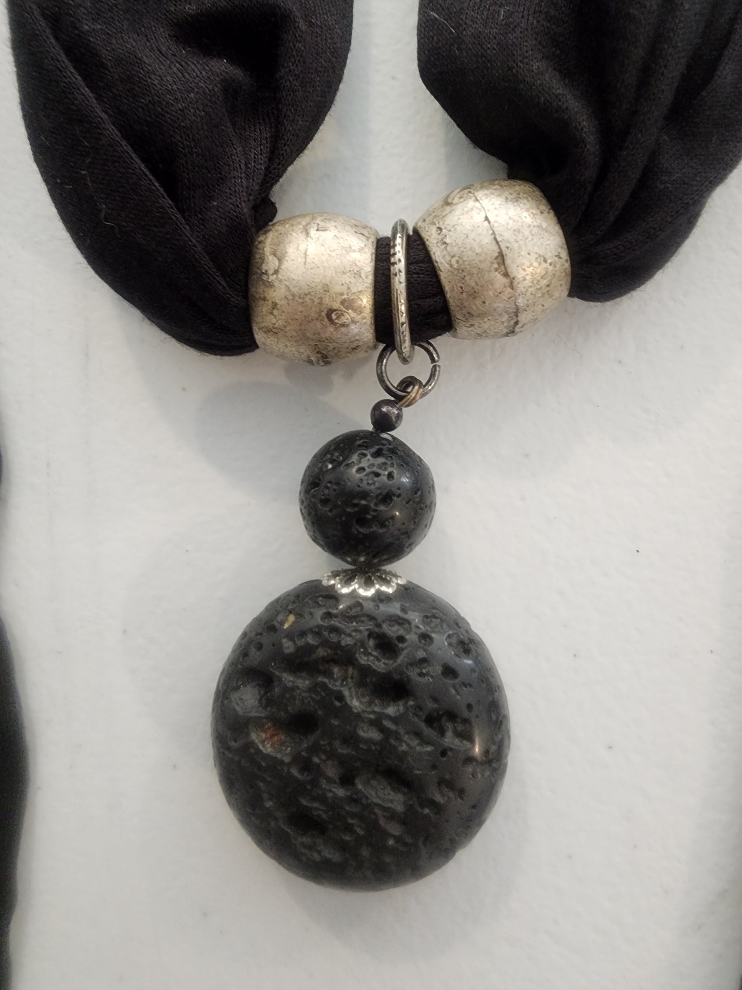<span;>Black scarf with silver tone beads and black lava bead in middle of scarf.
