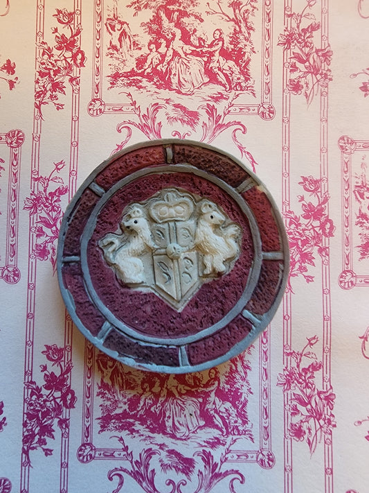 This is a plate or wall decor.  It could even be a window for a haunted house or castle.