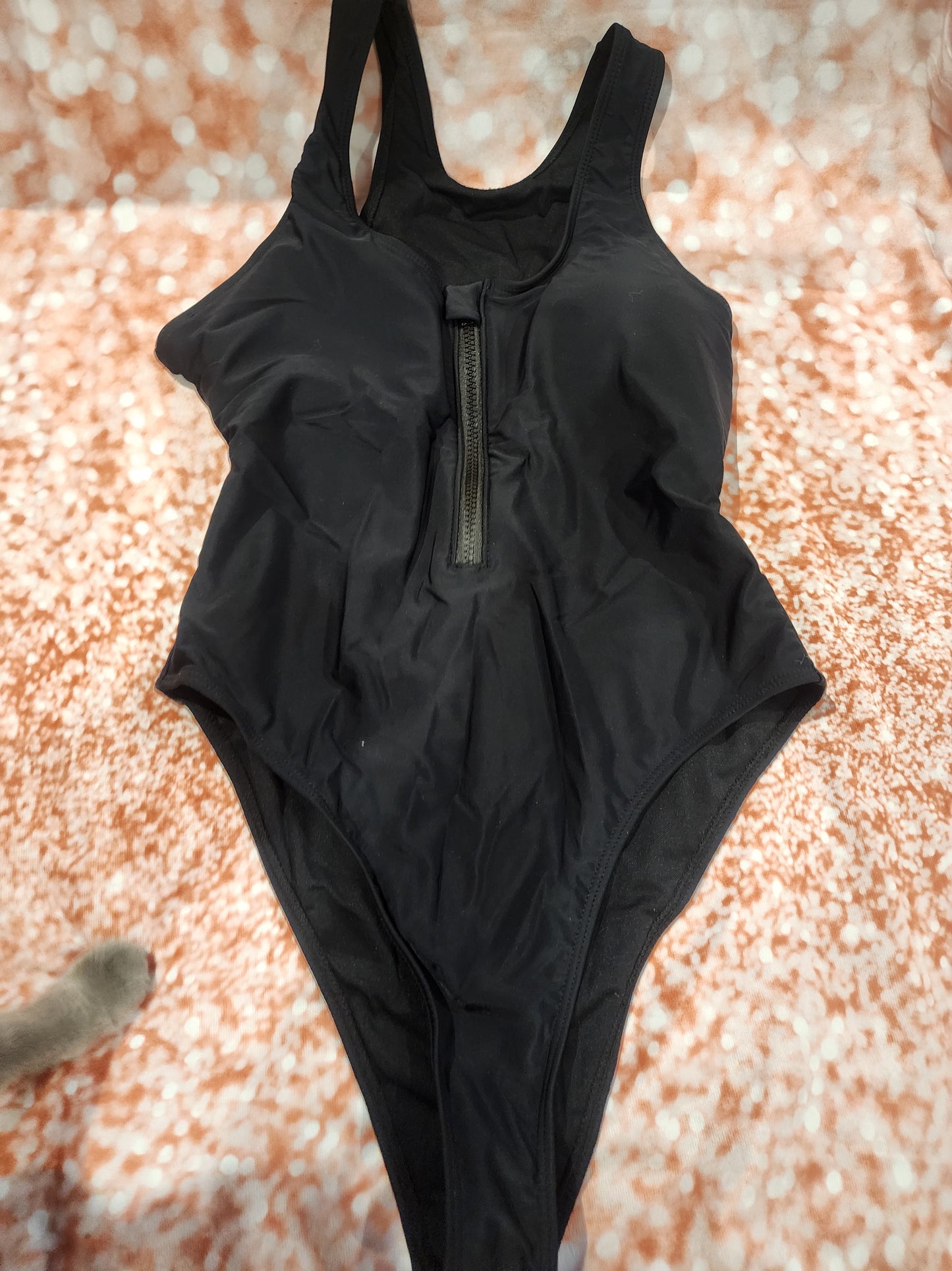 Sleek and stylish black one-piece swimsuit, perfect for the beach or pool L