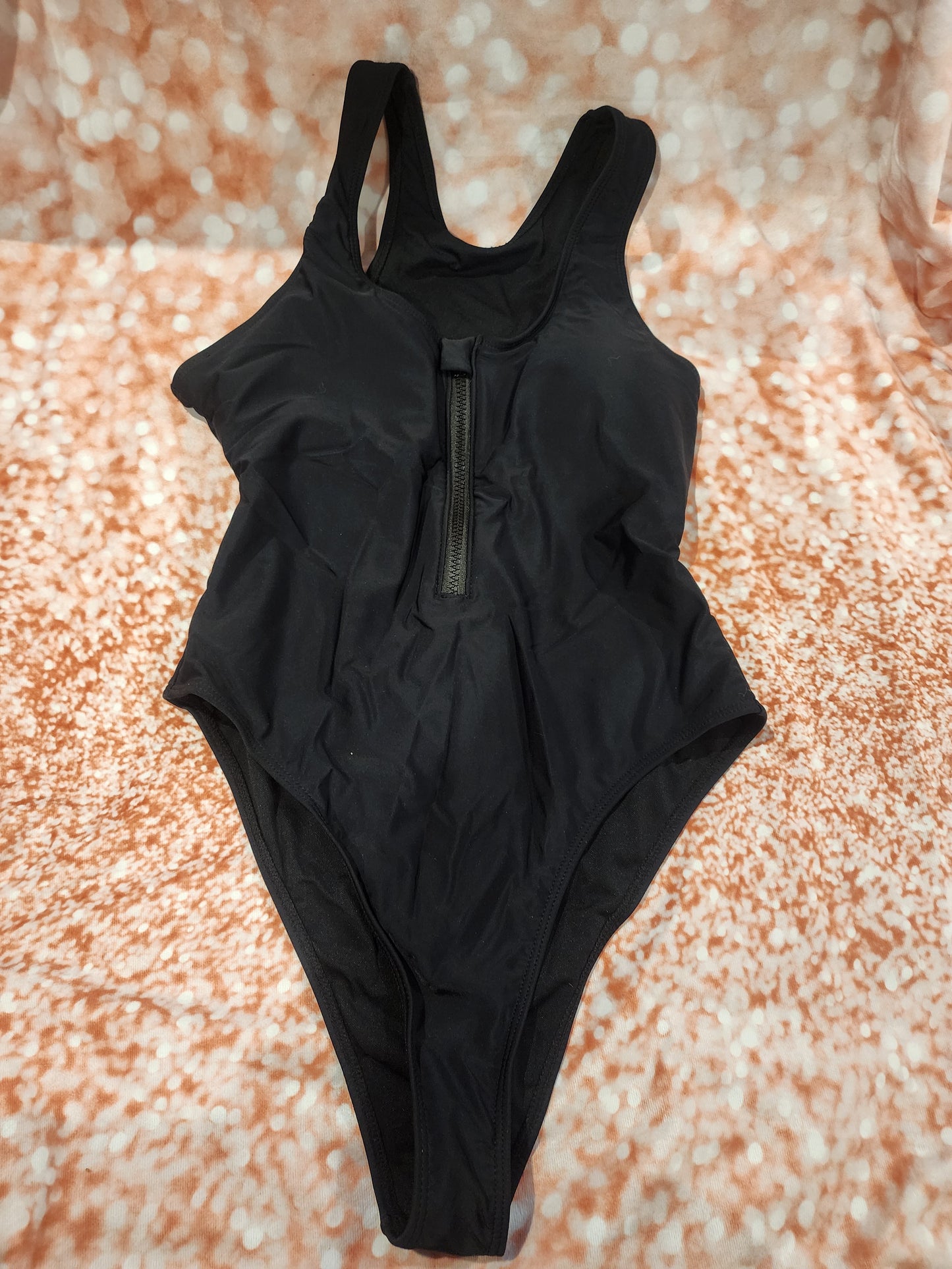 Sleek and stylish black one-piece swimsuit, perfect for the beach or pool L