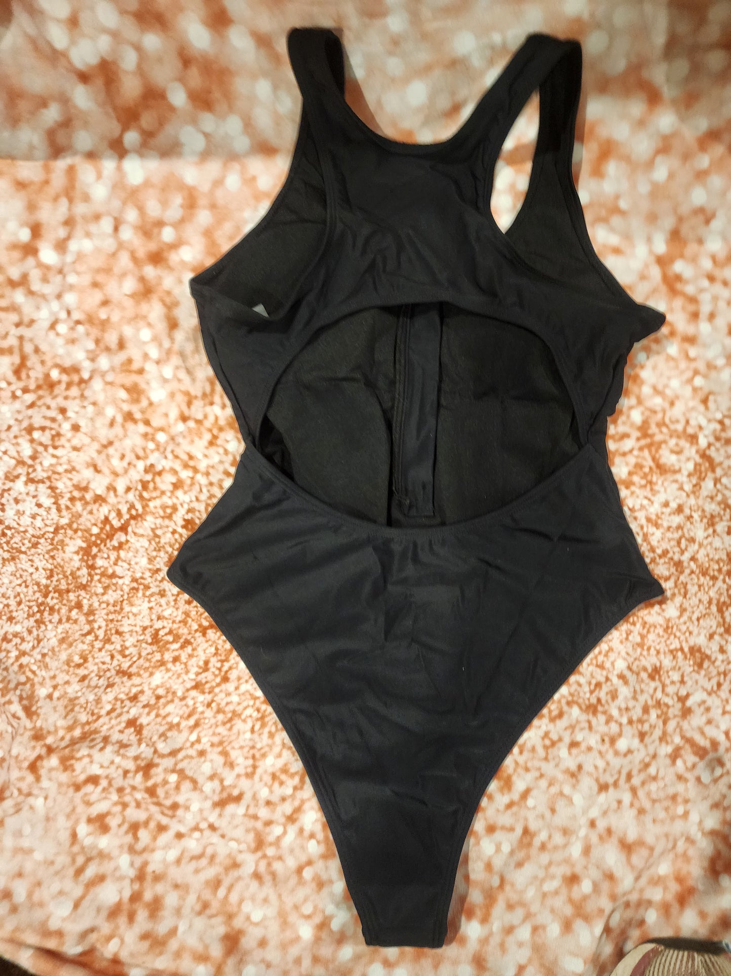 Sleek and stylish black one-piece swimsuit, perfect for the beach or pool L