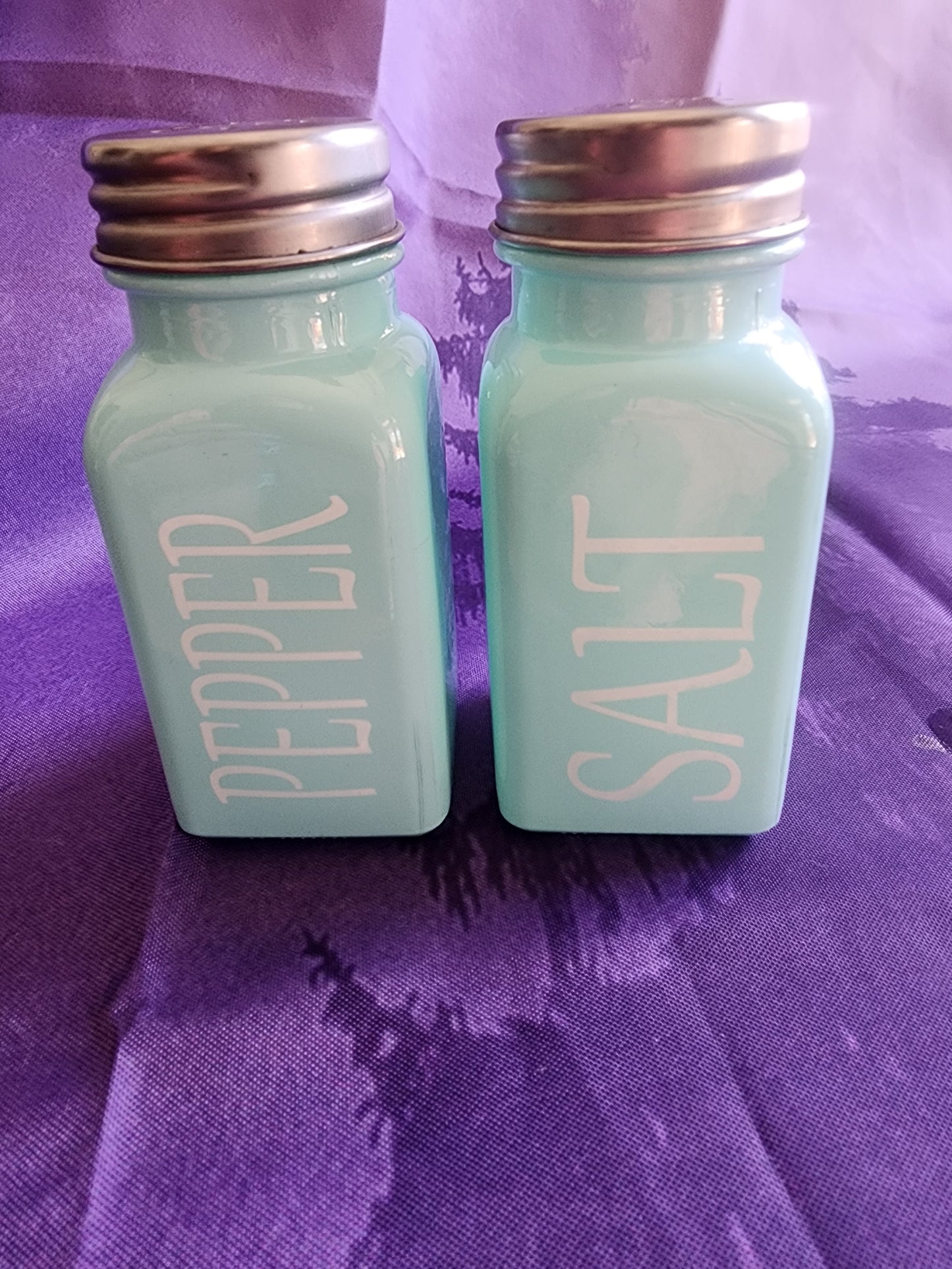 Salt &  Pepper Shakers Turquoise Glass and stainless steel tops.
