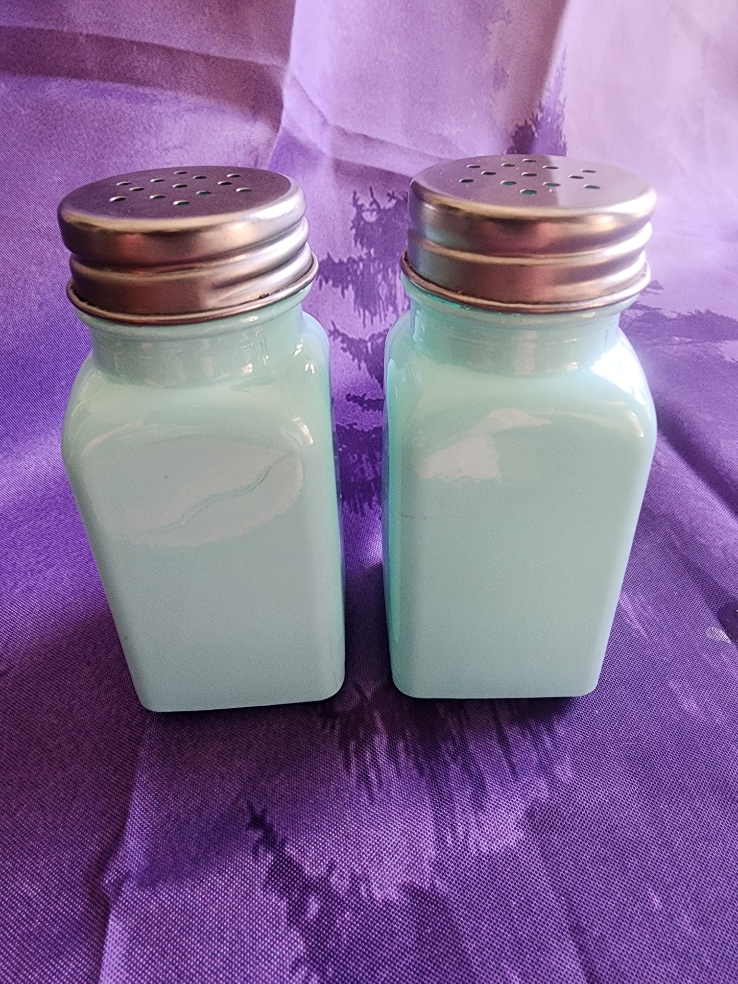 Salt &  Pepper Shakers Turquoise Glass and stainless steel tops.
