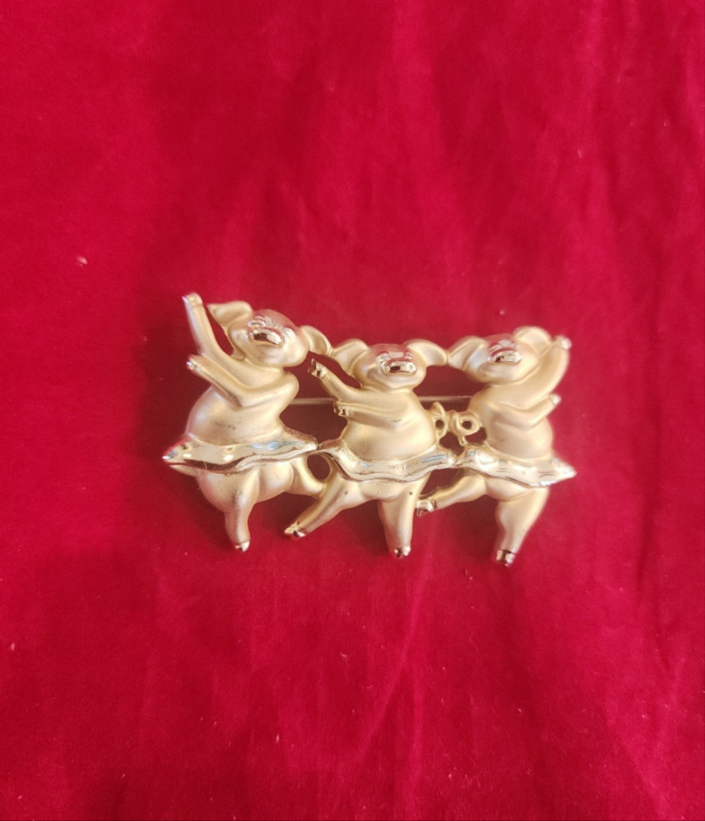 "Whimsical Dancing Pigs Pin! This charming gold-tone brooch