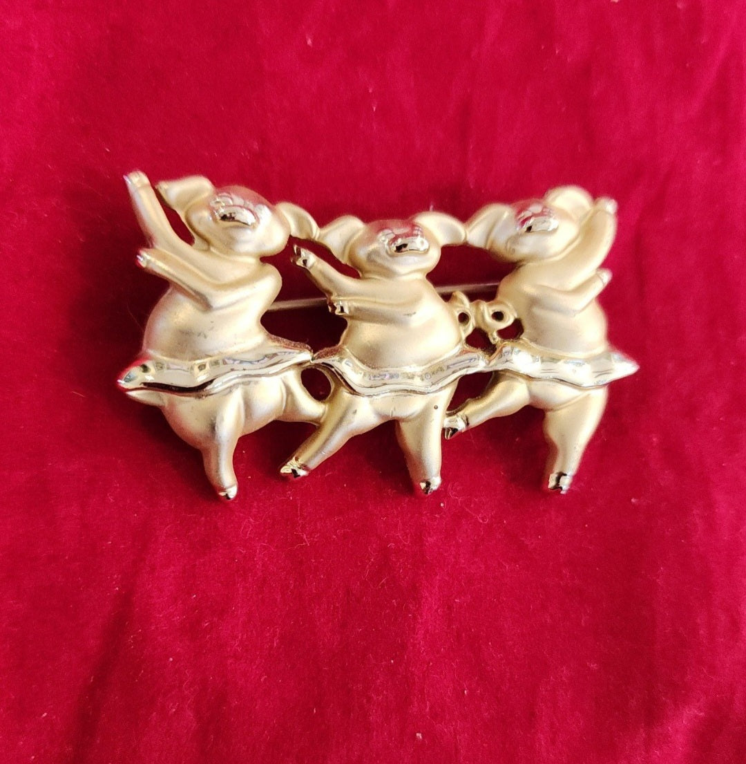 "Whimsical Dancing Pigs Pin! This charming gold-tone brooch