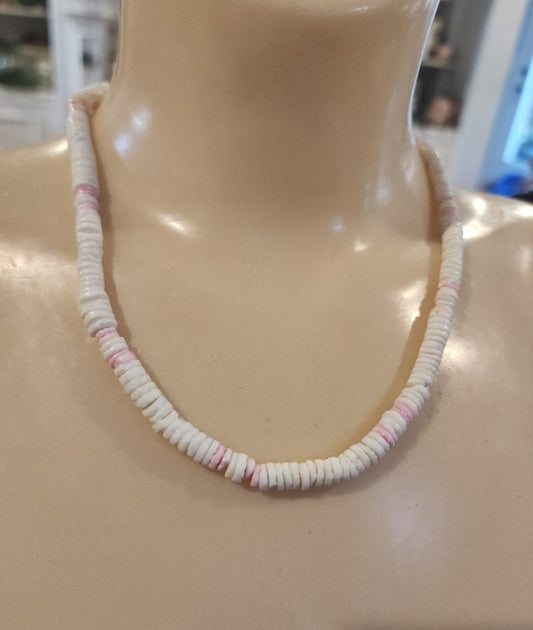 Vintage Puka shell necklace brings the island vibes! Features white and pink shells on a 17" strand