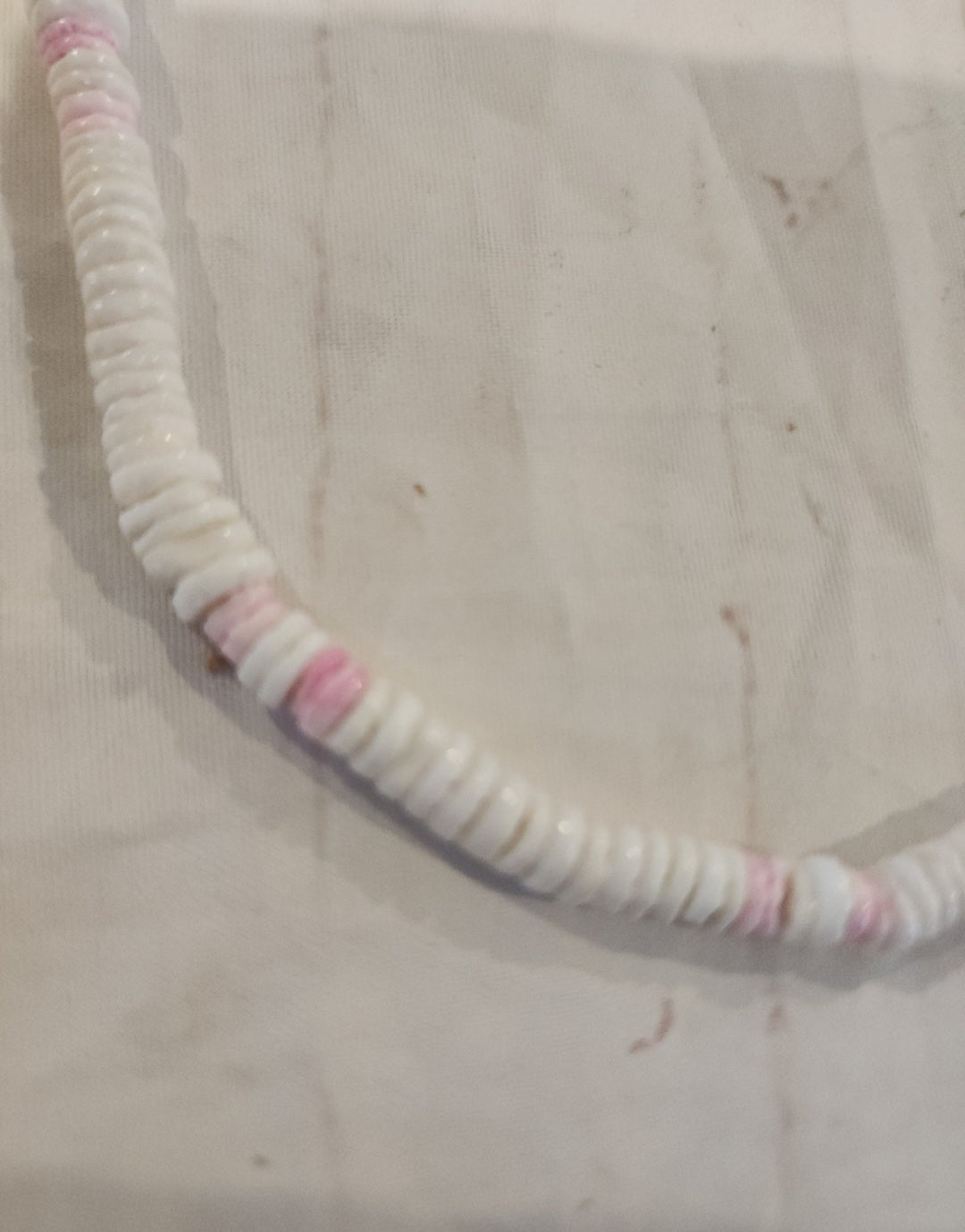 Vintage Puka shell necklace brings the island vibes! Features white and pink shells on a 17" strand