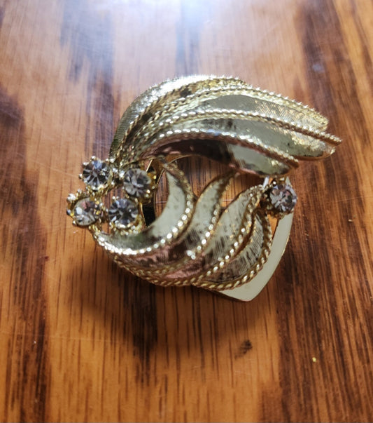 Elegant gold-tone Scarf Clip features sparkling rhinestones and a unique design