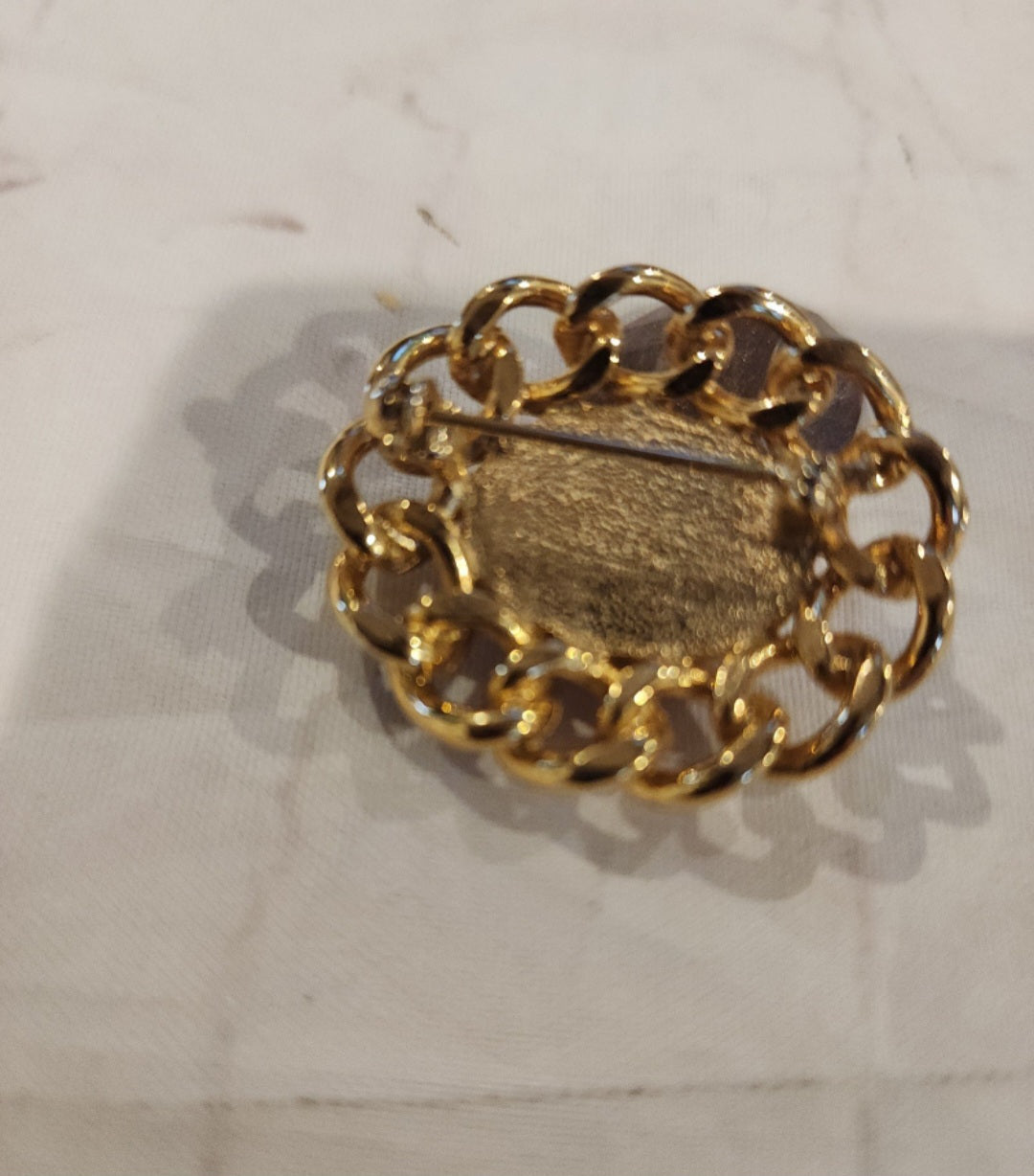 Vintage Unsigned Red Dome Brooch encased in a Gold tone setting.