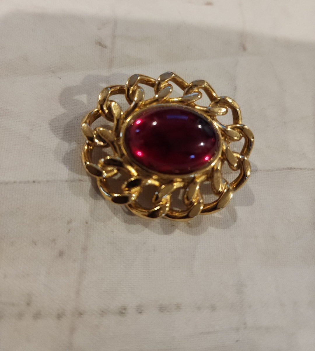 Vintage Unsigned Red Dome Brooch encased in a Gold tone setting.