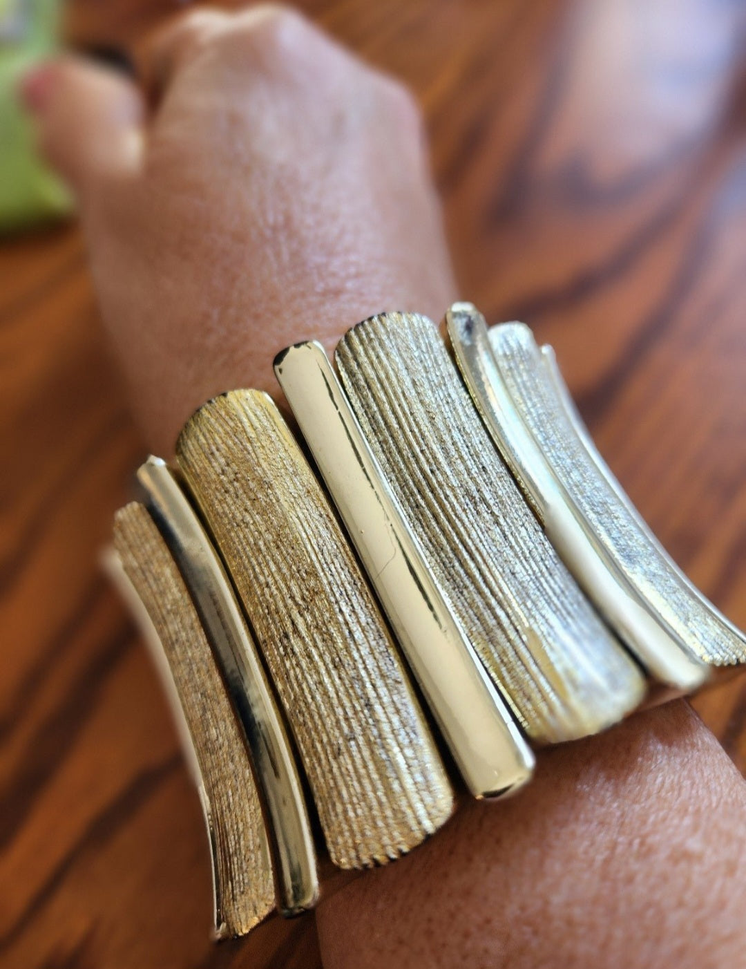 This vintage gold-tone bracelet boasts a striking design with textured panels