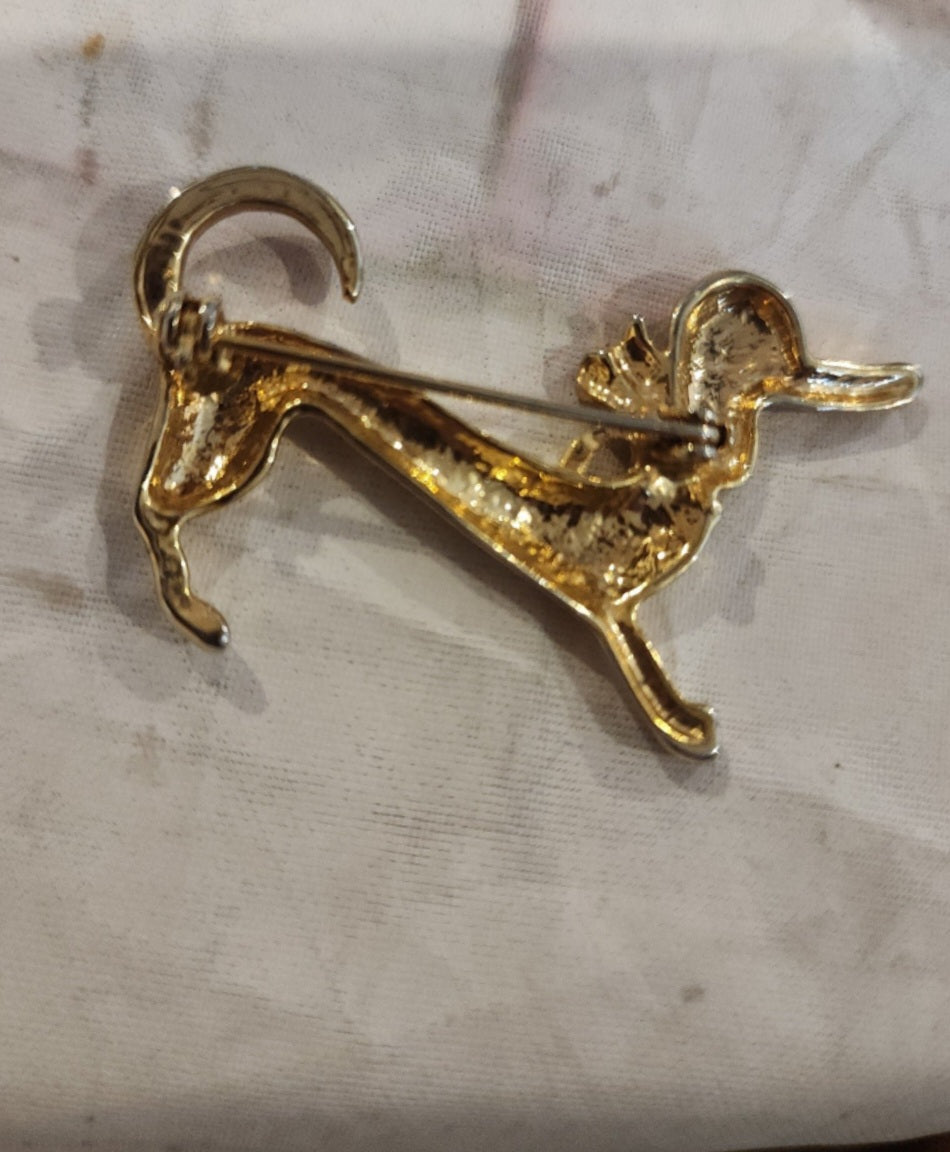 Vintage Gold Tone Dachshund Brooch. Sparkling rhinestones & green accents