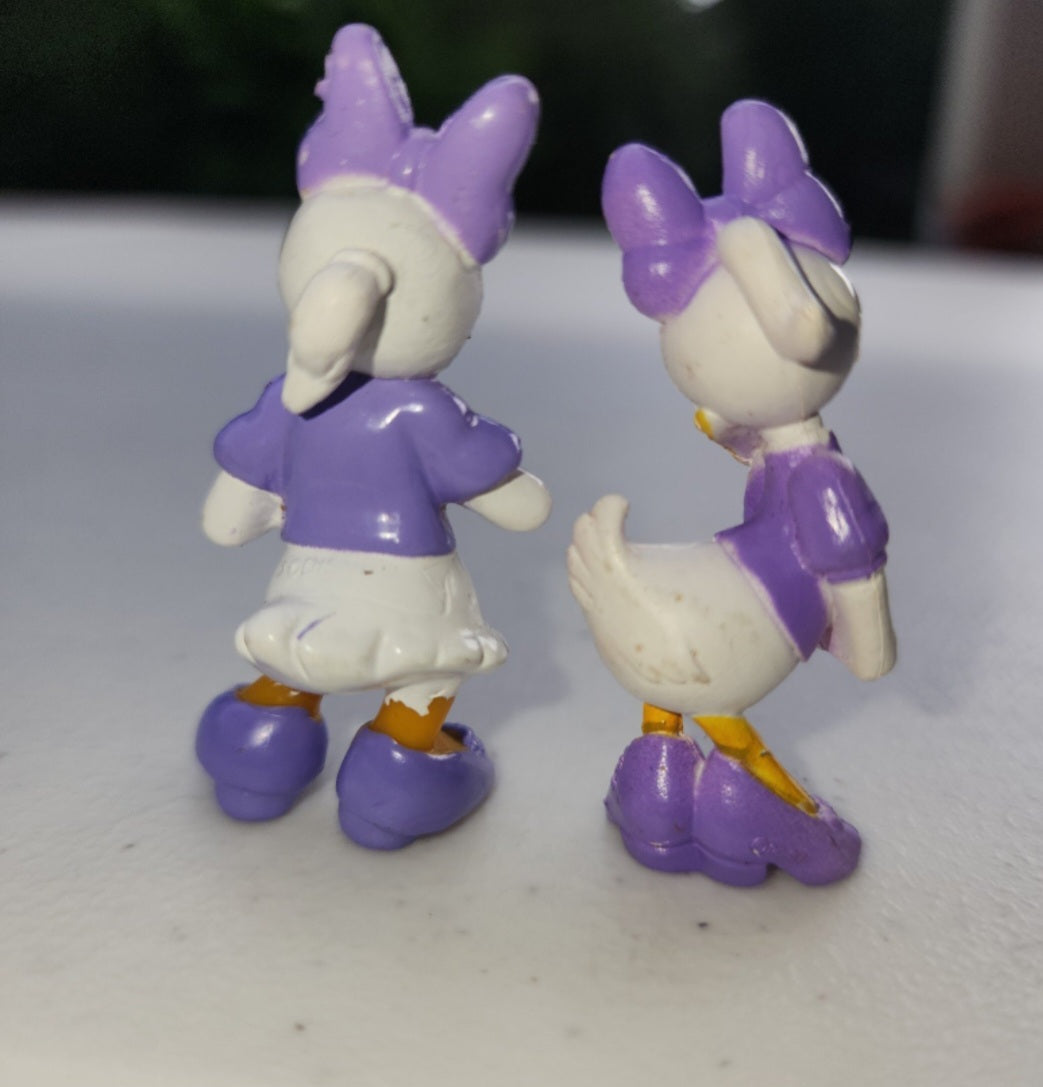 2 Adorable Disney Daisy Duck Figurines in purple made of pvc