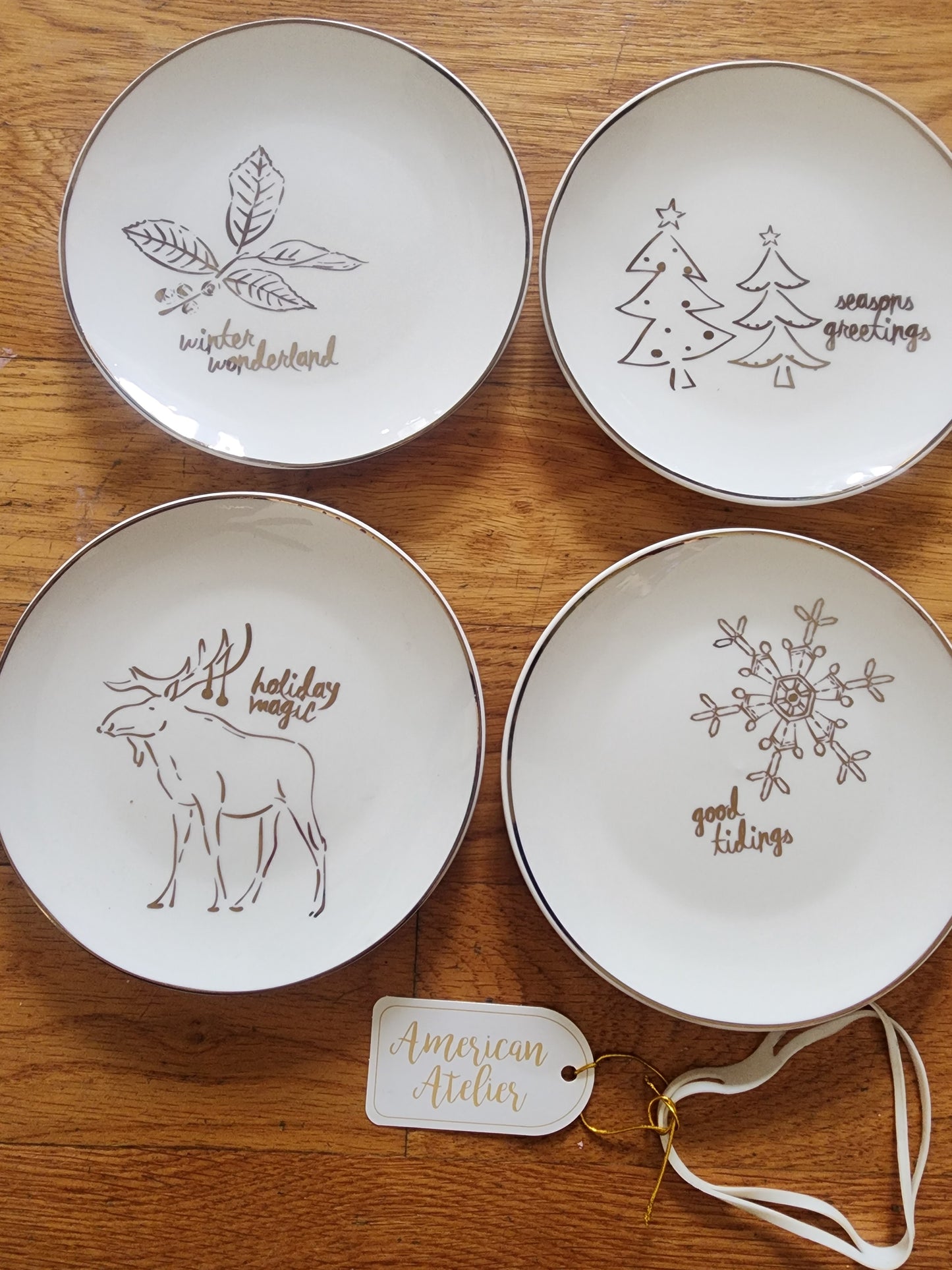 Four American Atelier holiday-themed dessert plates. Christmas