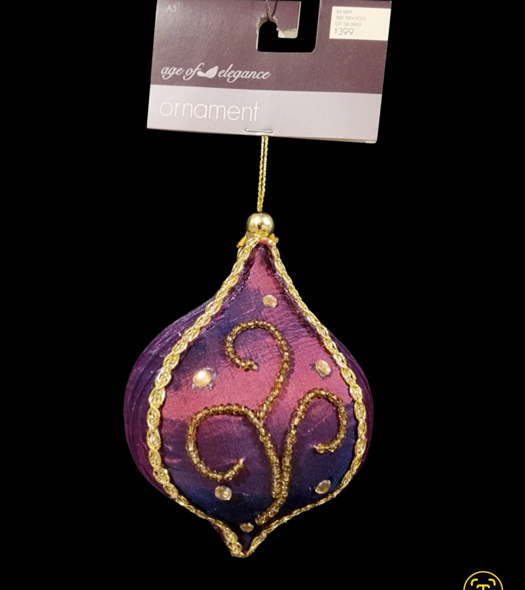 Purple ornament, made of fabric with gold-colored beading and faux gems