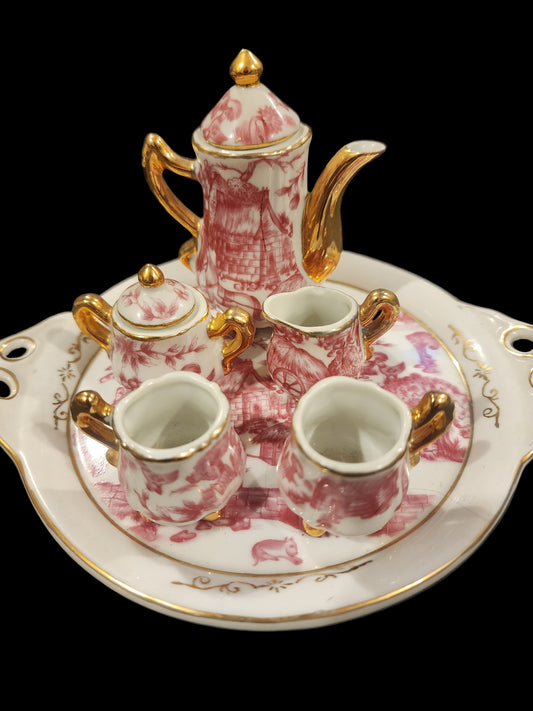 Miniature porcelain Tea Set with a pink toile or chintz pattern and gold gilt