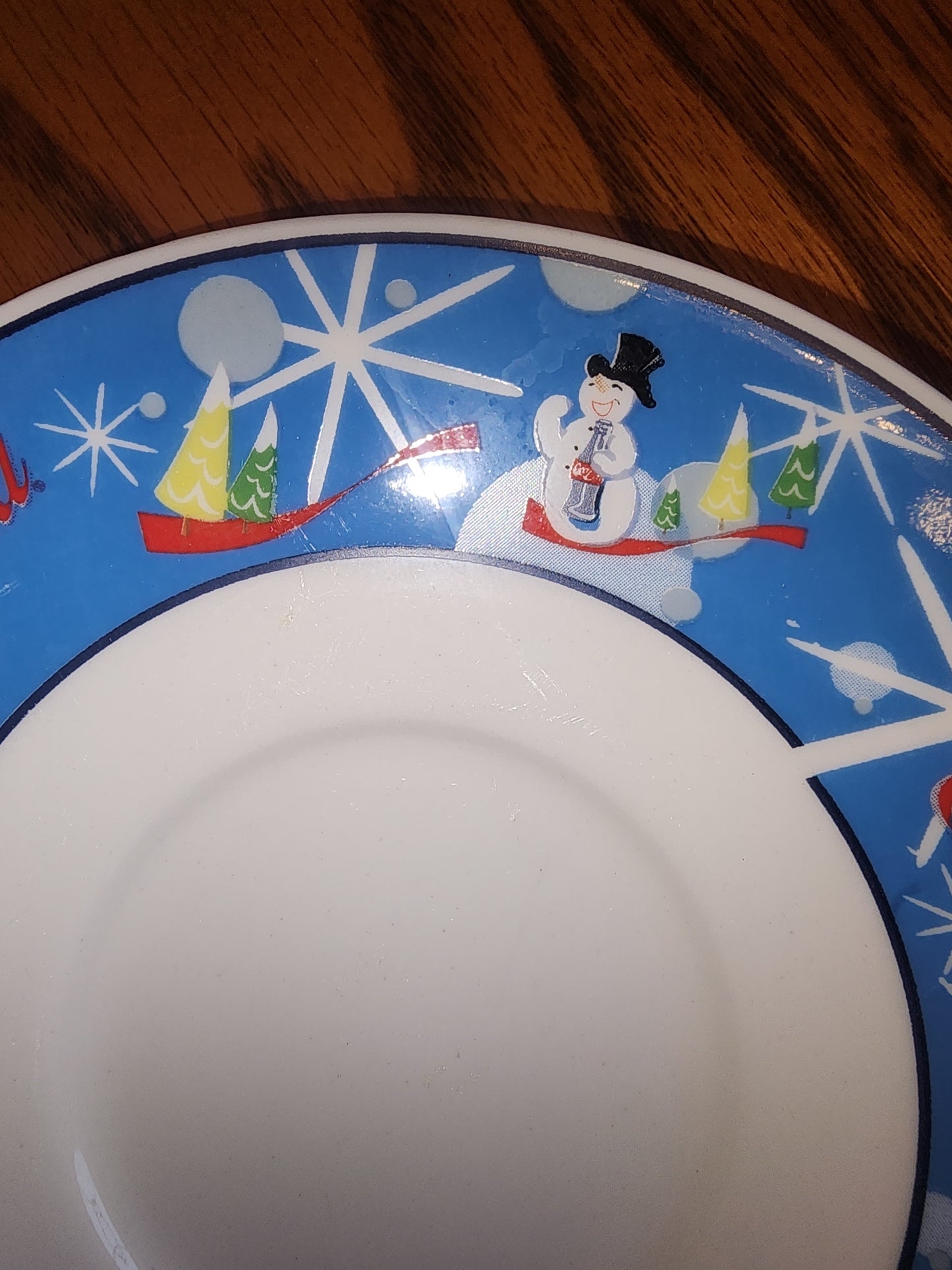 The Coca Cola Company Laughing Snowman.  2 Saucers.  Blue, red, white.