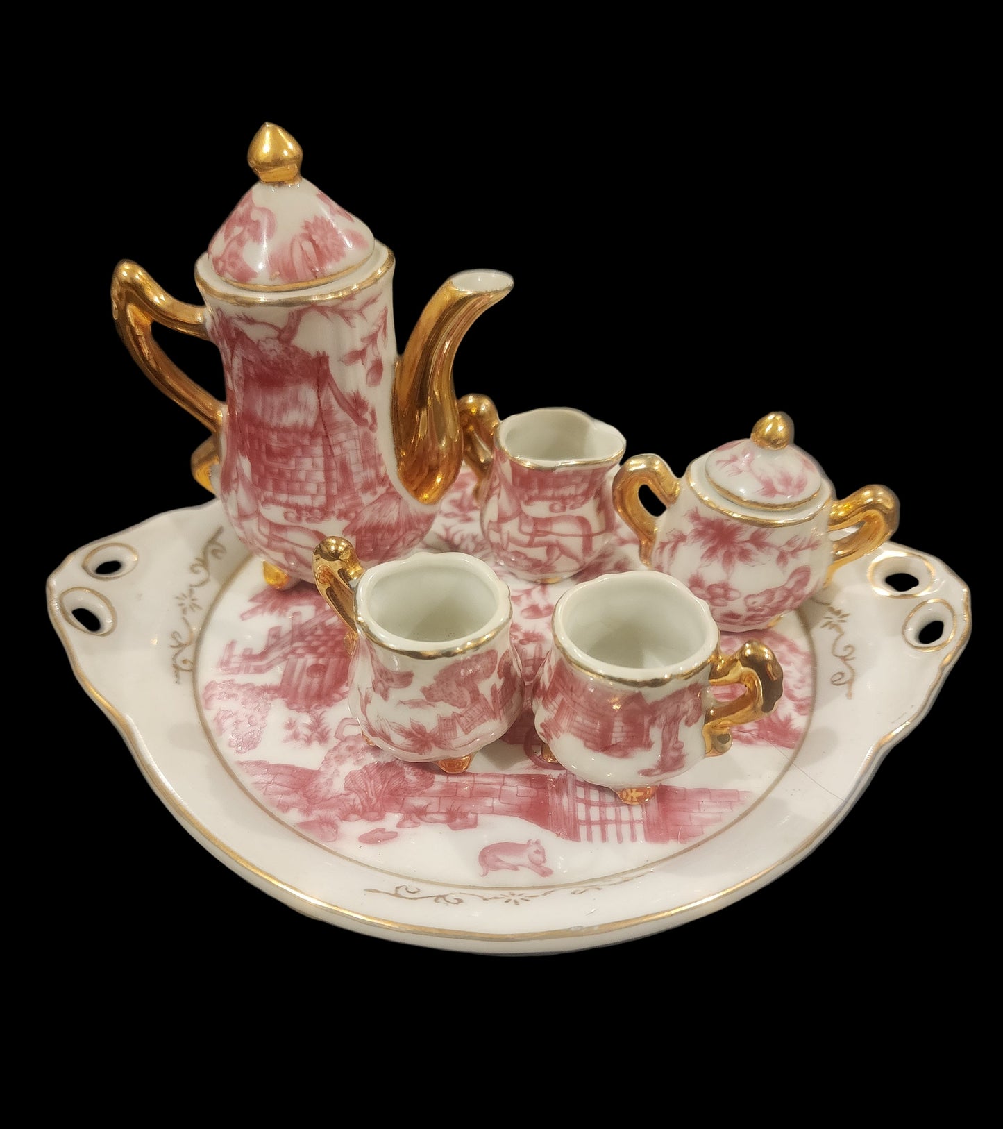 Miniature porcelain Tea Set with a pink toile or chintz pattern and gold gilt
