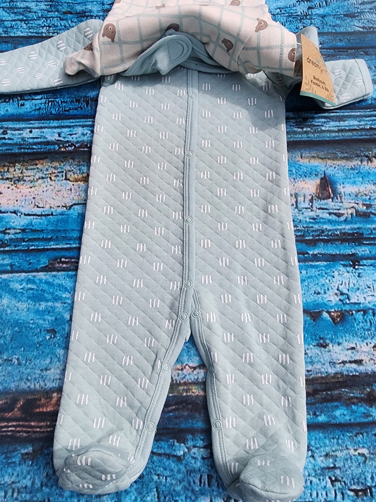 Dreamgro 3-piece baby outfit set. Includes a long-sleeved quilted footie, a short-sleeved bodysuit with bear print, and a "So Beary Cute!" bib. Size 6-9 months.