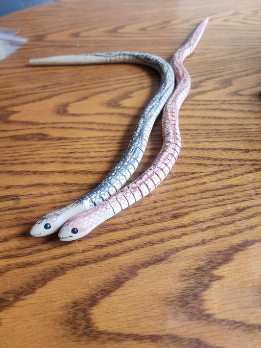 2 WOODEN WIGGLE SNAKES. Hand Painted. Realistic snake like action.in good condition.  Aprox. 20" long.