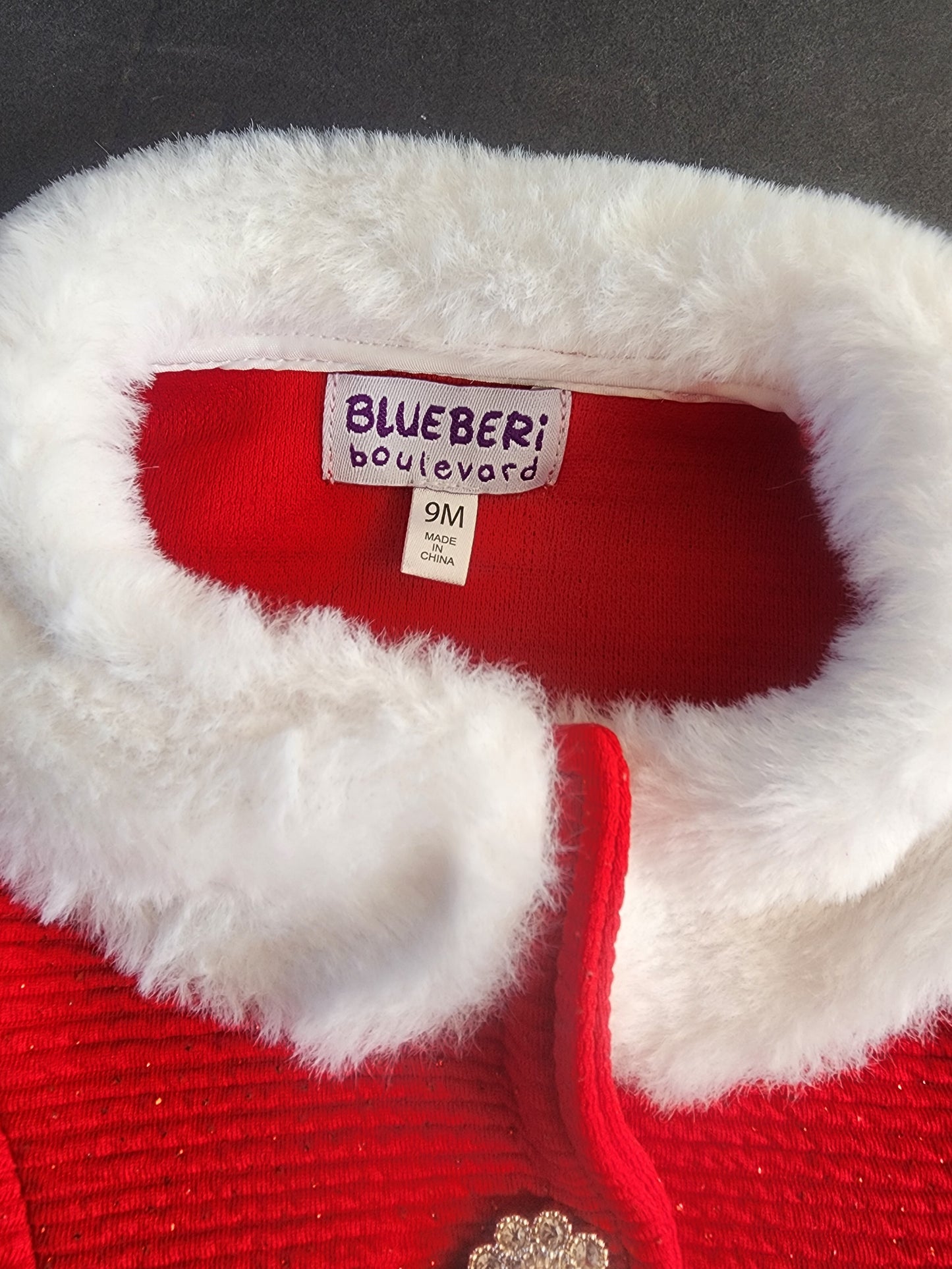 This is an adorable, festive infant girl's light coat 9 months