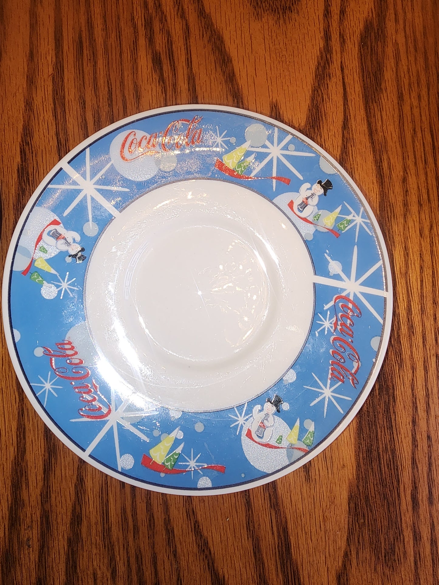 The Coca Cola Company Laughing Snowman.  2 Saucers.  Blue, red, white.