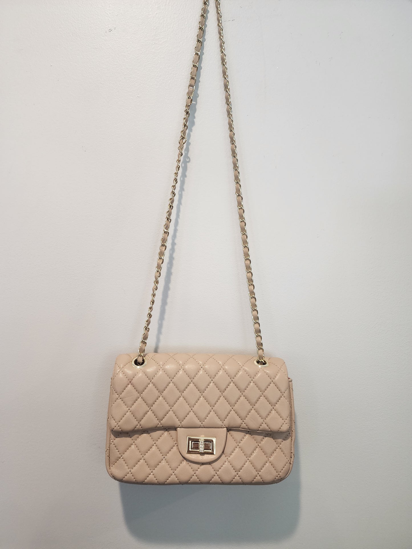 Quilted Leather beige purse with gold tone accents and chain.