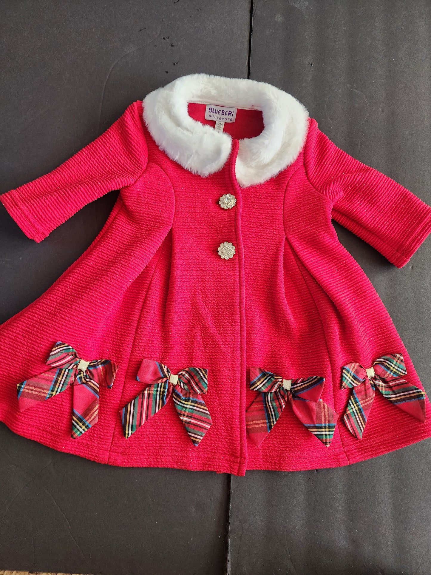 This is an adorable, festive infant girl's light coat 9 months