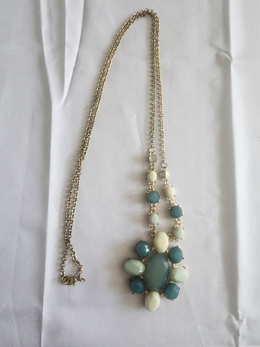 This vintage necklace features a stunning cluster of teal and cream stones