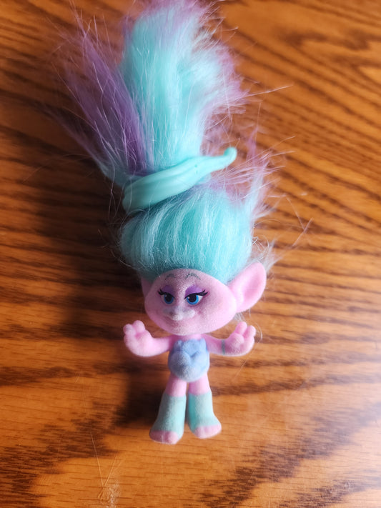 DreamWorks Trolls Chenille mini toy figurine.
The figure has a flocked (fuzzy) pink body and face.