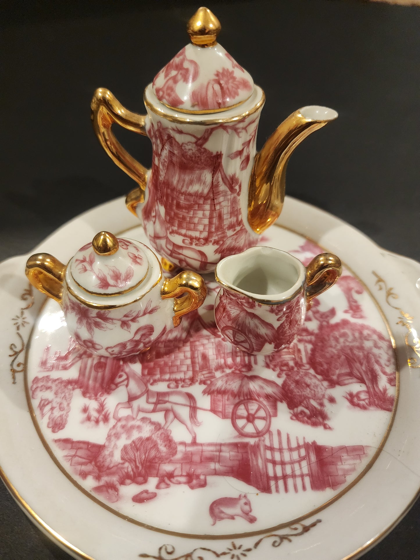 Miniature porcelain Tea Set with a pink toile or chintz pattern and gold gilt