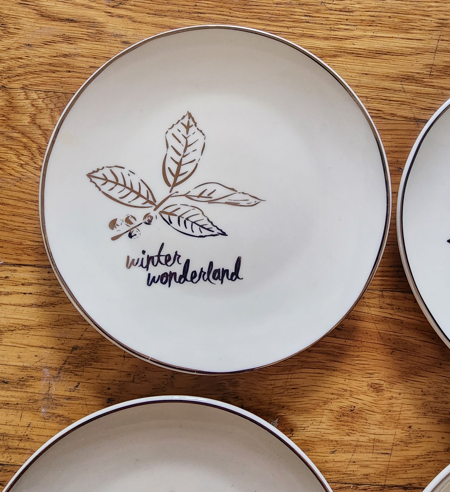 Four American Atelier holiday-themed dessert plates. Christmas