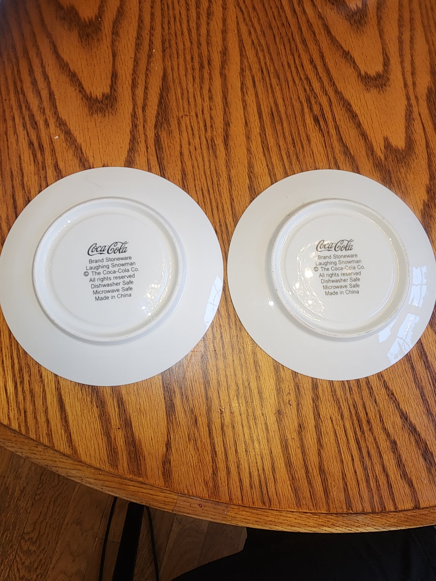 The Coca Cola Company Laughing Snowman.  2 Saucers.  Blue, red, white.