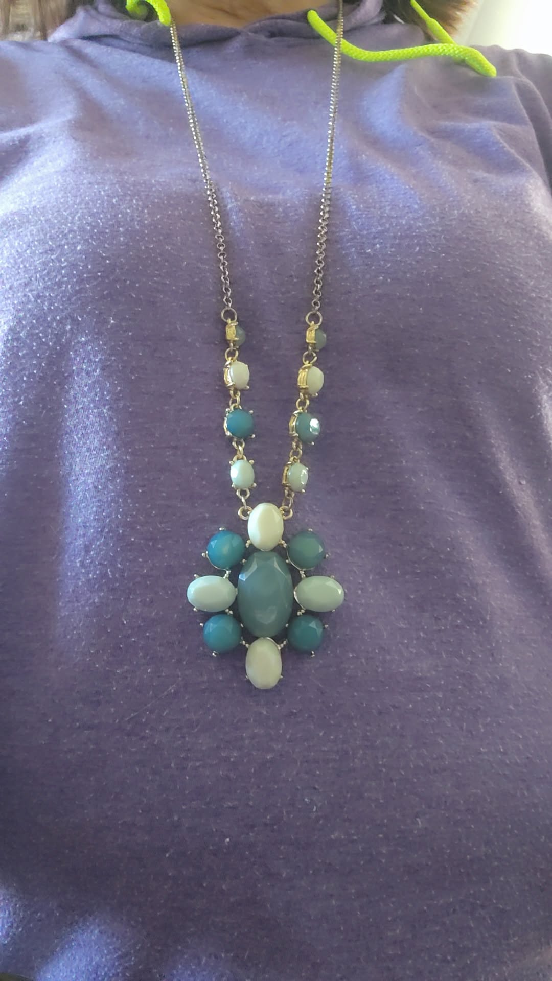 This vintage necklace features a stunning cluster of teal and cream stones