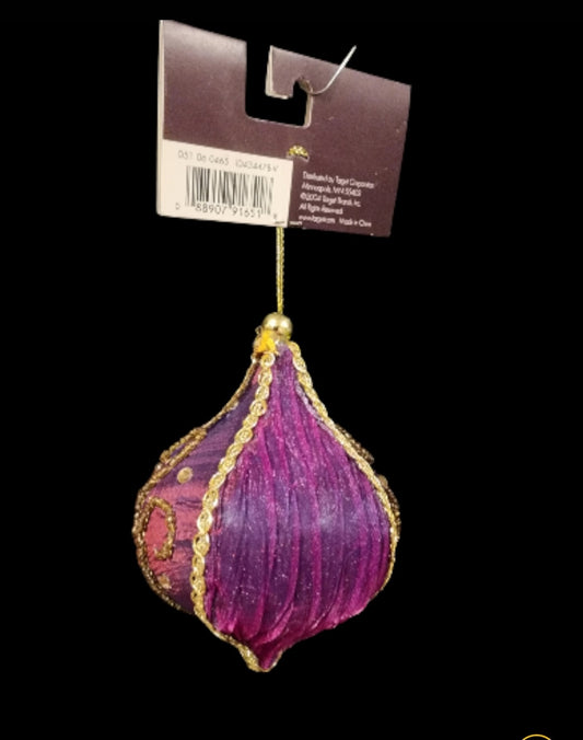 Purple ornament, made of fabric with gold-colored beading and faux gems