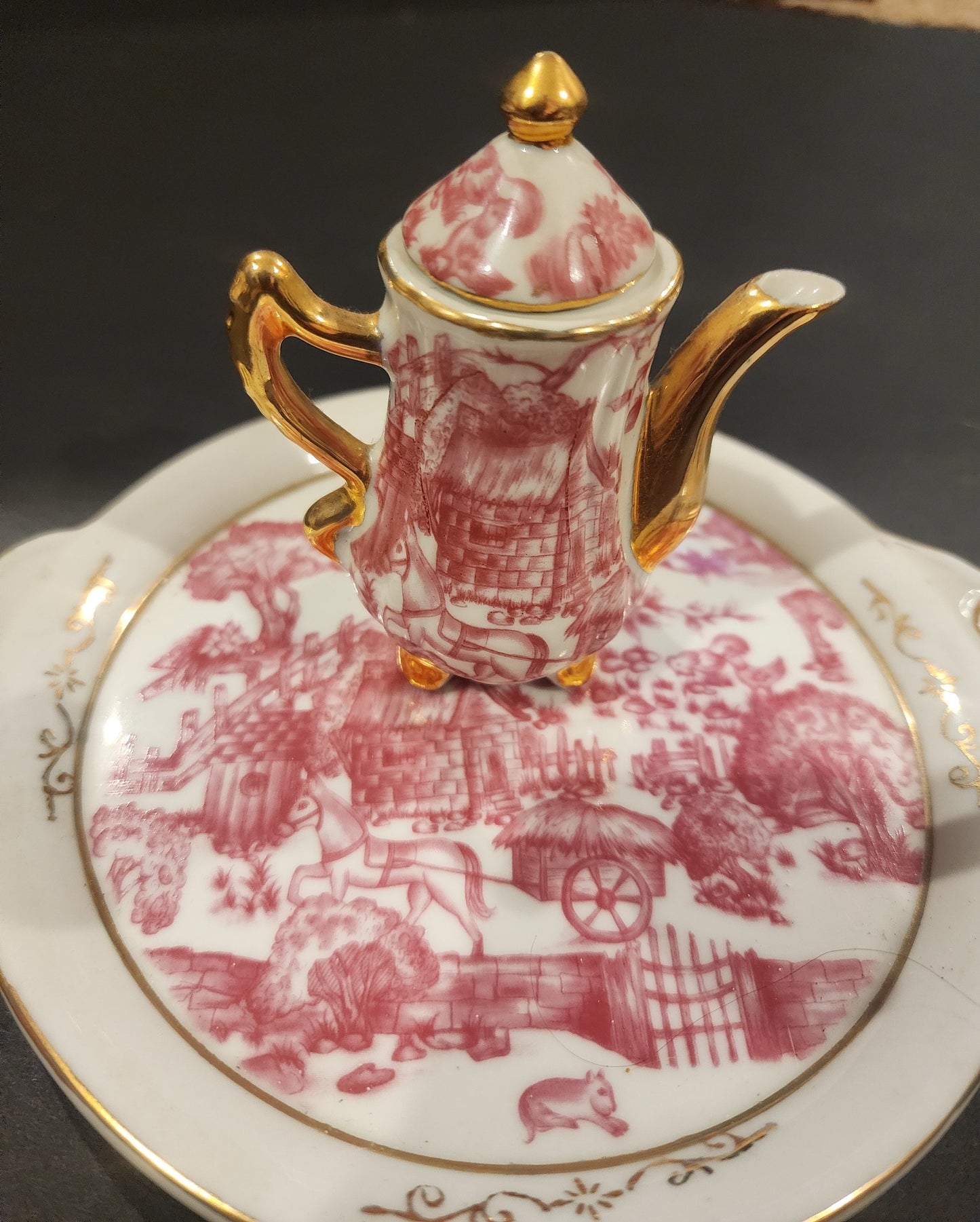 Miniature porcelain Tea Set with a pink toile or chintz pattern and gold gilt
