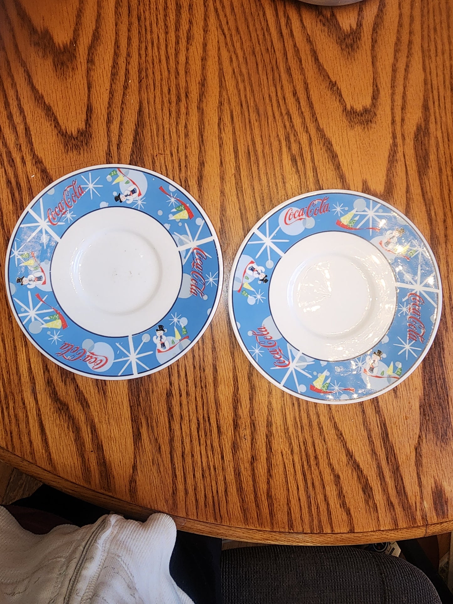 The Coca Cola Company Laughing Snowman.  2 Saucers.  Blue, red, white.