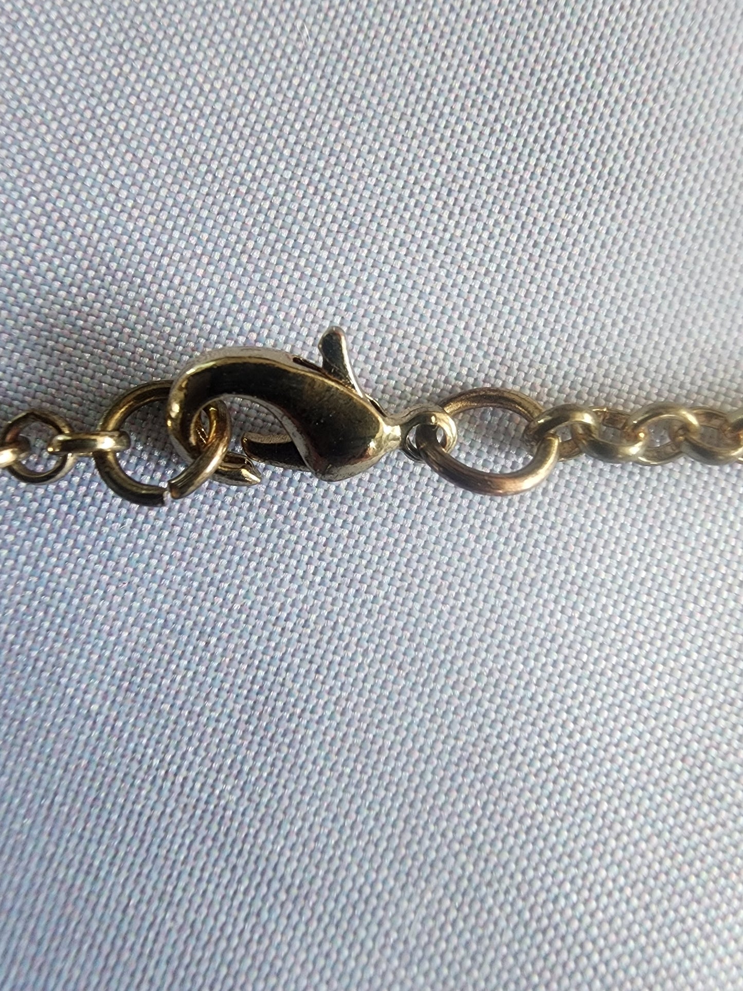 This vintage necklace features a stunning cluster of teal and cream stones